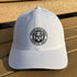 White cap with a black logo on a wooden surface